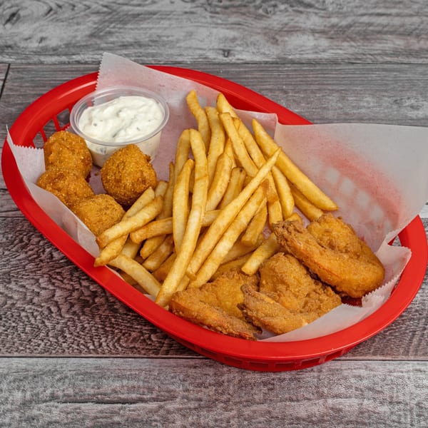 A red basket filled with golden-brown fried fish, hush puppies, french fries, and a side of tartar sauce.
